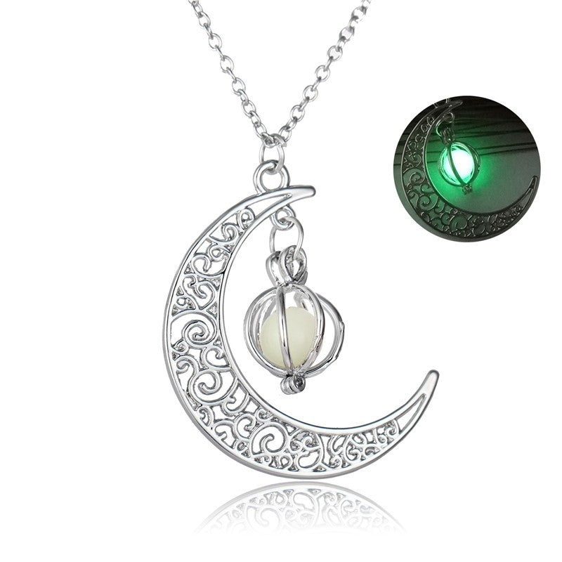 metal crescent moon with white pendent  