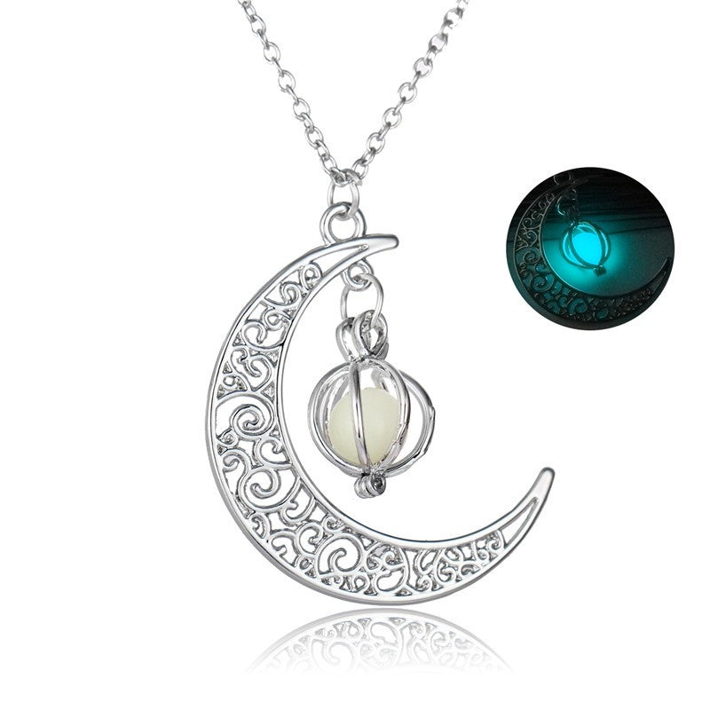 metal crescent moon with white pendent  