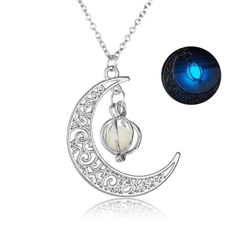 metal crescent moon with white pendent  