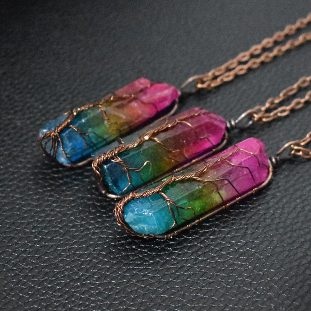 three multi color crystals wrapped in wire